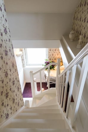 Staircase leads to an upper level with a simple, clean design and a welcoming atmosphere.