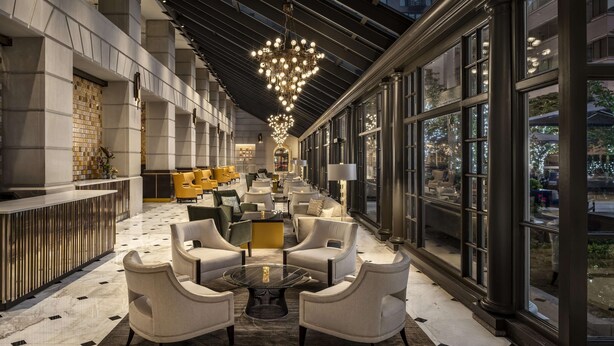 A spacious lobby with a high ceiling, modern furniture, and large windows offering views of the outside. - Fairmont Washington, D.C., Georgetown (Washington)