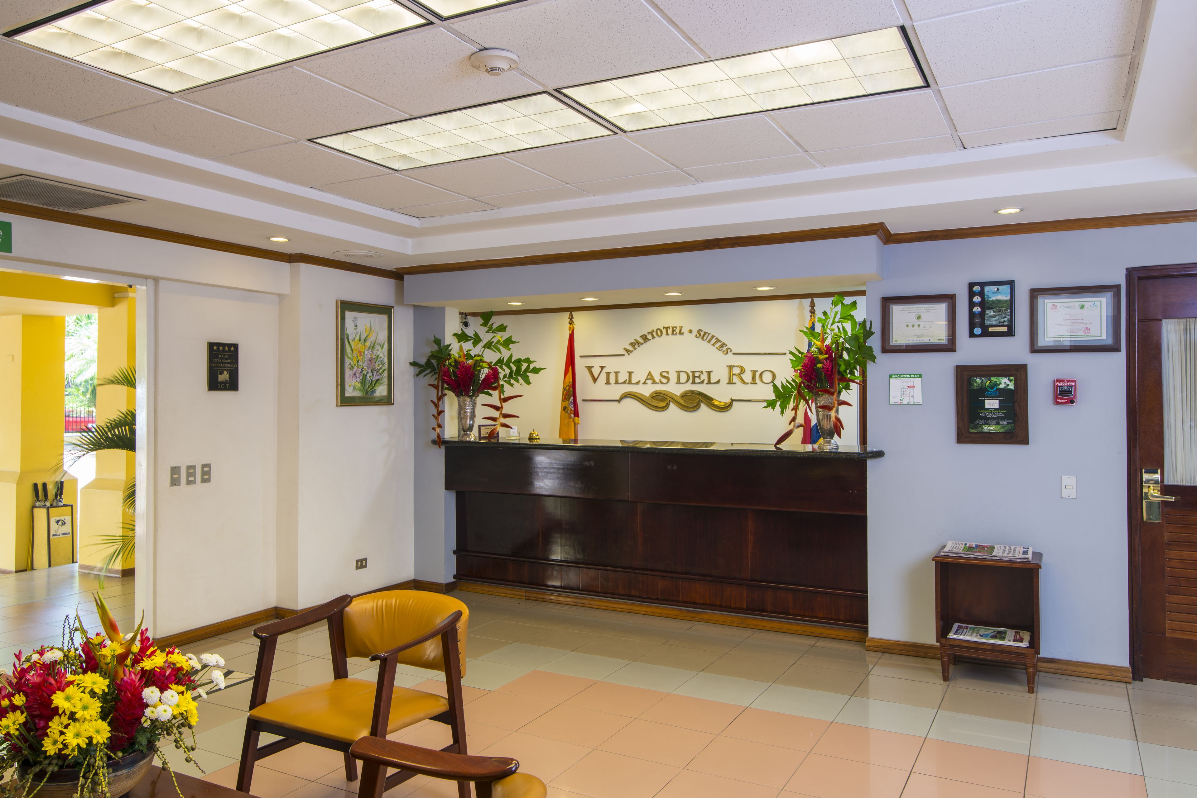 A reception area with a reception desk, a chair, and a small table with magazines.