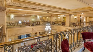 A grand hotel lobby with ornate railings, a chandelier, and a staircase. - The Fort Garry Hotel, Spa and Conference Centre, an Ascend Collection Hotel (Winnipeg)