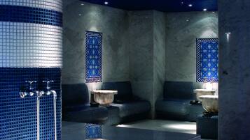 Relax in a serene space with a curved bench and flat table, surrounded by a starry night sky ceiling and blue patterned tiles.