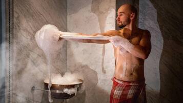 A person pouring a liquid from a tray into a pot.