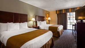 A hotel room with two beds, a desk, a television, and a window with curtains. - Best Western Green Valley Inn (Green Valley)
