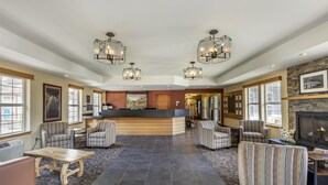 A spacious lobby with a central reception desk, multiple seating areas, and a fireplace. - Best Western Plus Columbia River Inn (Cascade Locks)