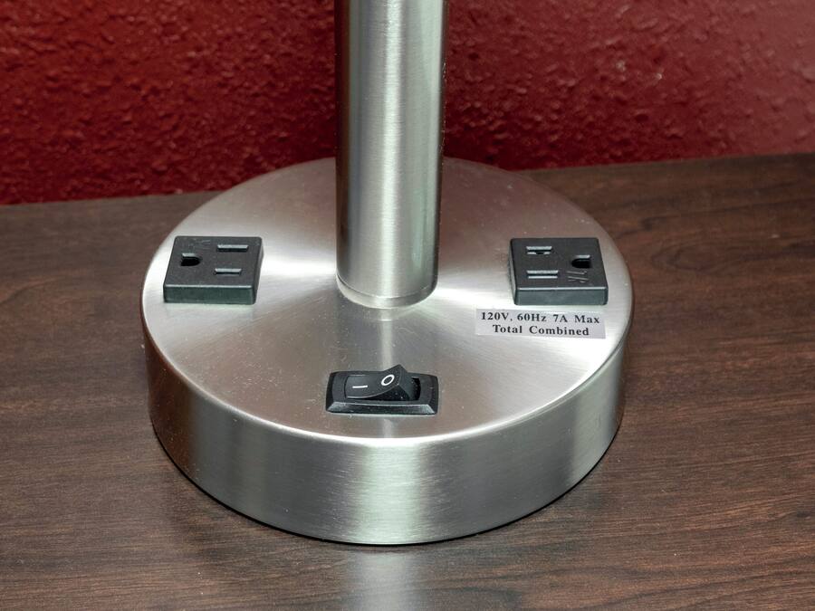 A metallic base with two electrical outlets and a switch, labeled for 120V, 60Hz, 7A Max, total combined.