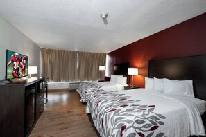 A hotel room with a bed, a desk, a TV, and a window with curtains. - Red Roof Inn Marion, VA (Marion)