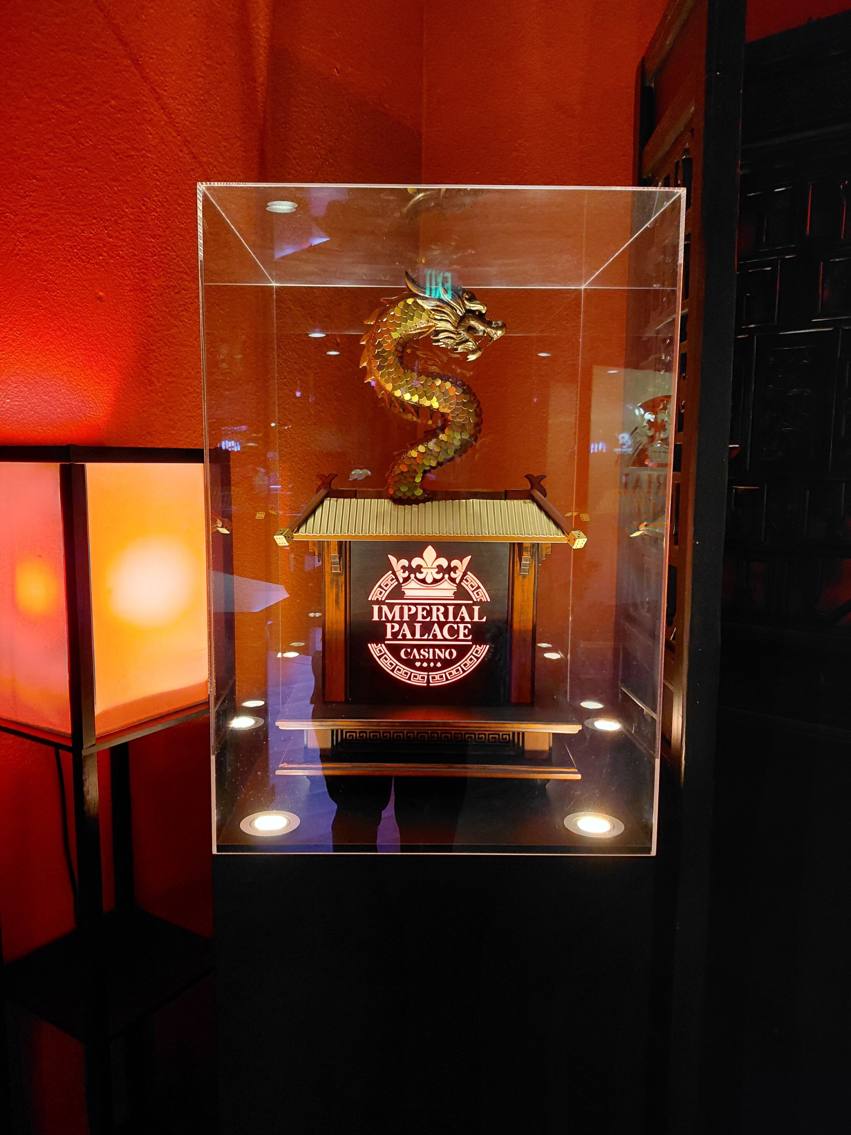 A display case with a golden dragon and a building labeled 'Imperial Palace Casino.'