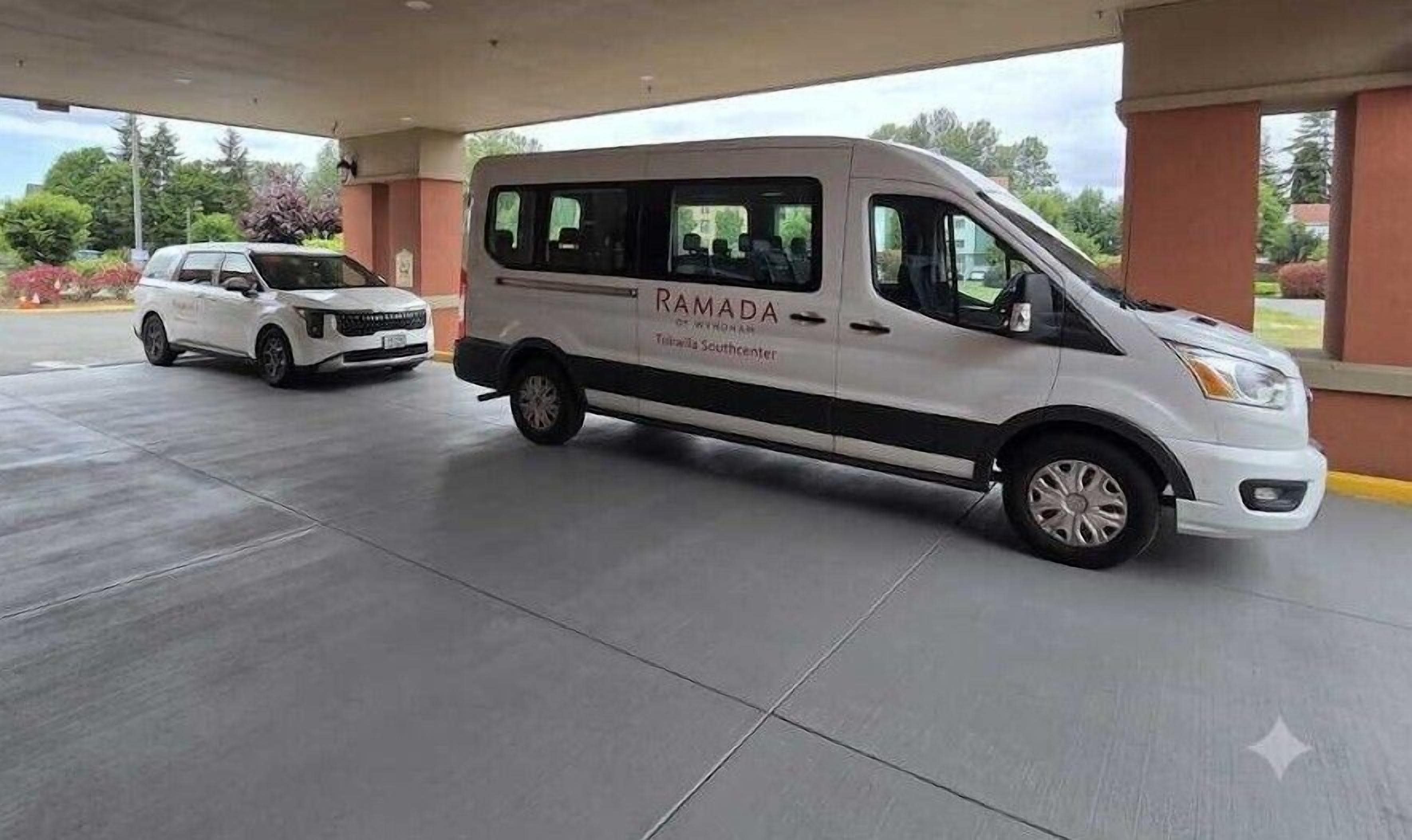 A white van with 'RAMADA' and 'Tucson Southcenter' on the side parked at a gas station.