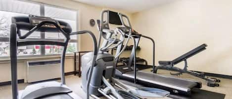 A gym with treadmills, ellipticals, and a stationary bike.