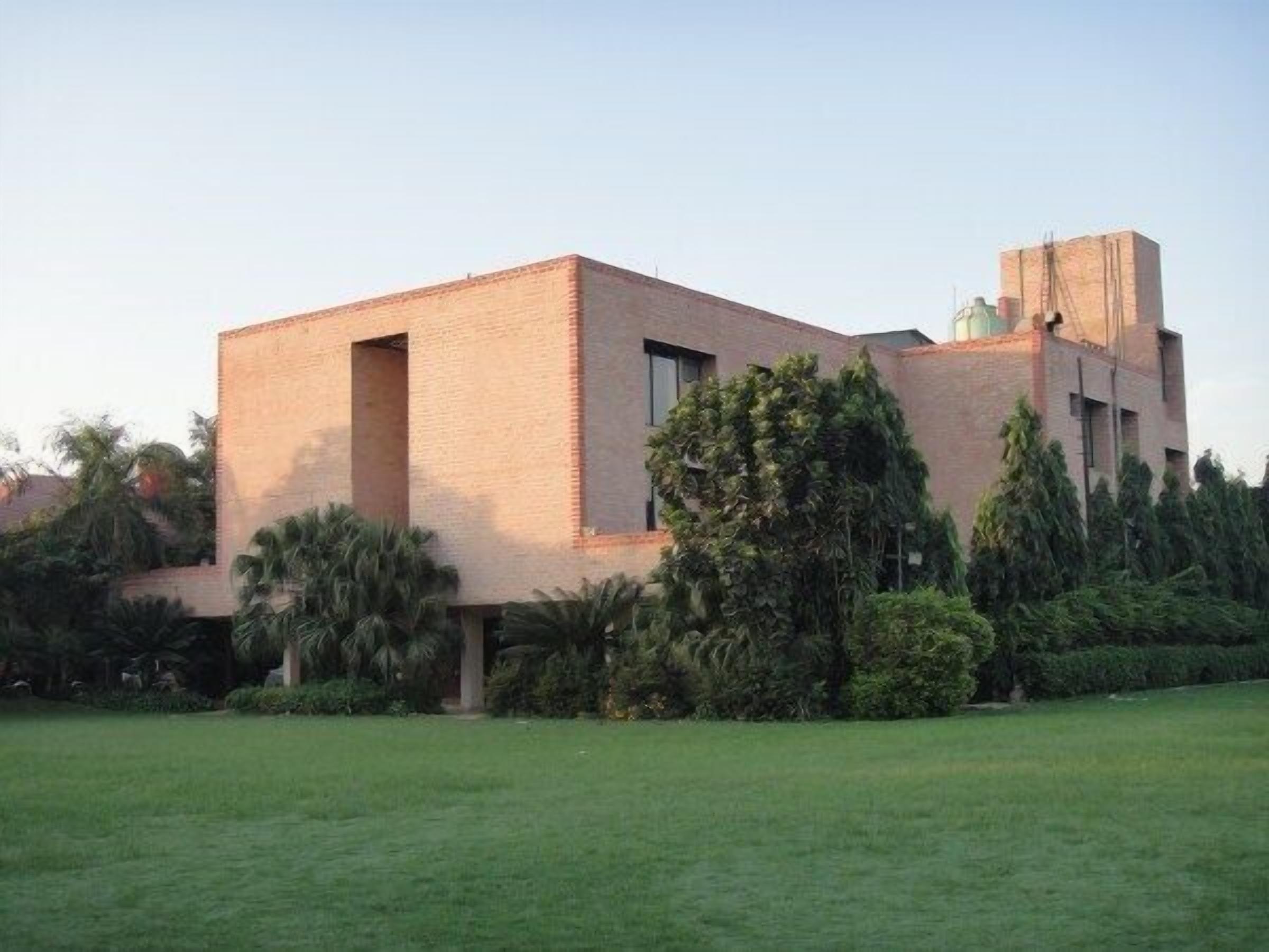 A modern building with a rectangular shape, large windows, and a flat roof.