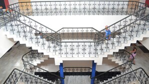 A multi-level staircase with ornate metal railings and marble steps. - The Radha Ashok (Mathura)