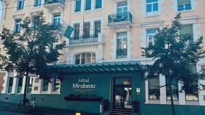 A multi-story hotel with a classic architectural style, featuring balconies and a prominent entrance. - Hotel Mirabeau, BW Signature Collection (Lausanne)