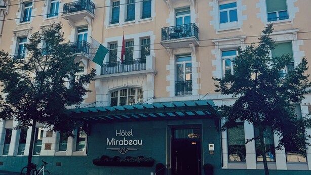 A multi-story hotel with a classic architectural style, featuring balconies and a prominent entrance.