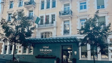 A multi-story hotel with a classic architectural style, featuring balconies and a prominent entrance.