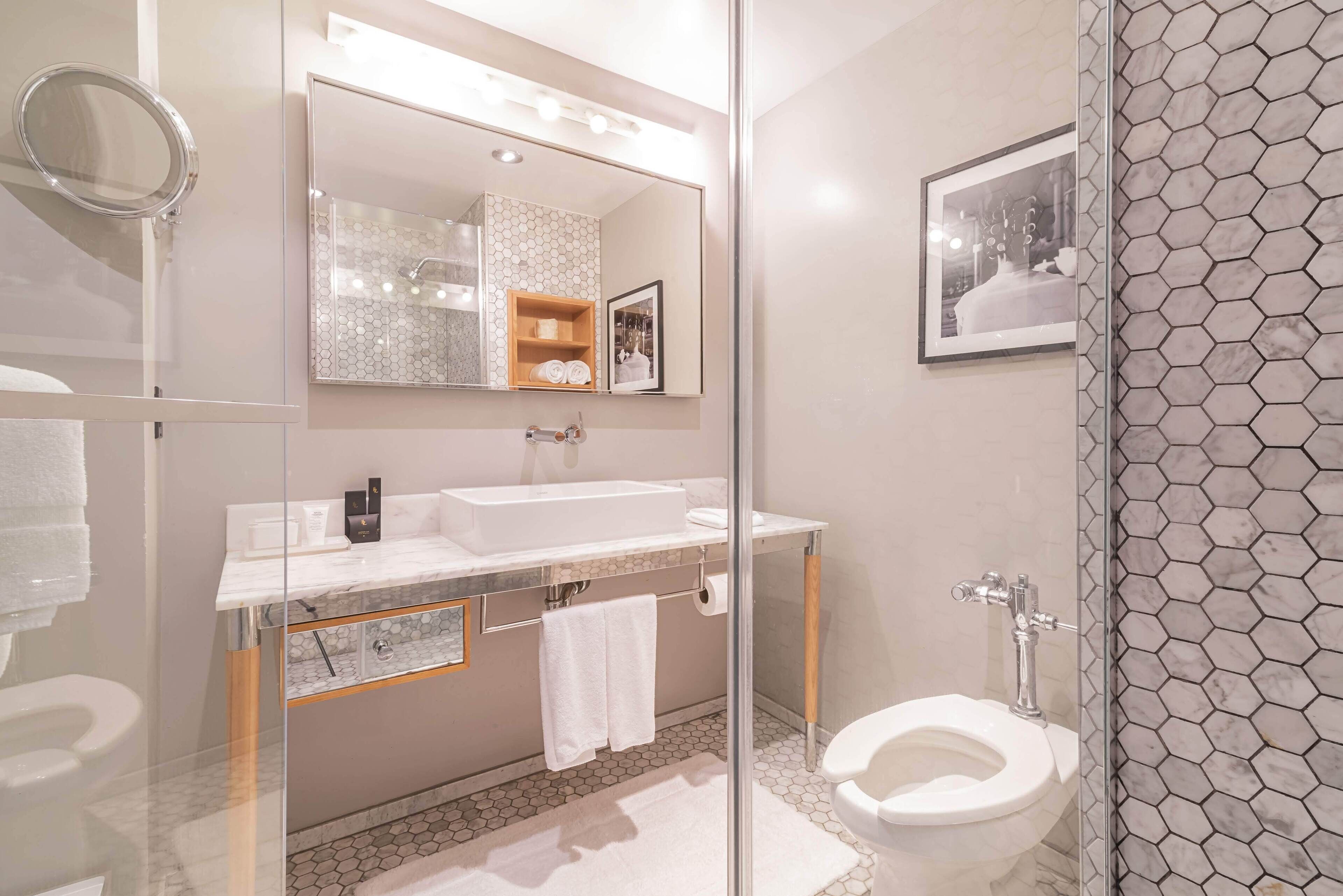 designer toiletries, hair dryer, towels, soap