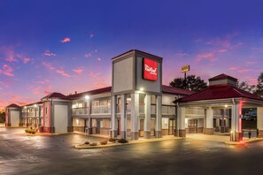 A Red Roof Inn with a two-story structure, a covered entrance, and a parking lot. - Red Roof Inn & Suites Athens, AL (Athens)
