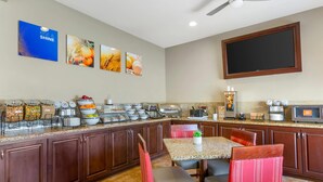 A breakfast bar with various food items and a coffee machine. - Comfort Inn Phoenix Central City (Phoenix)
