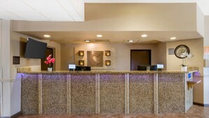 A reception area with a marble counter, a clock, and a welcome sign. - Comfort Inn Phoenix Central City (Phoenix)