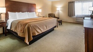 A hotel room with a large bed, two bedside tables, a chair, a desk, and a window with curtains. - Comfort Inn Salida (Salida)