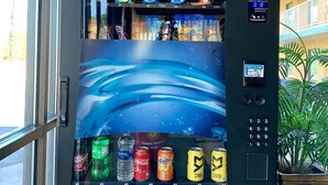 A vending machine with snacks and drinks, including brands like Lay's and Fanta. - Welcome Inn (Milledgeville)