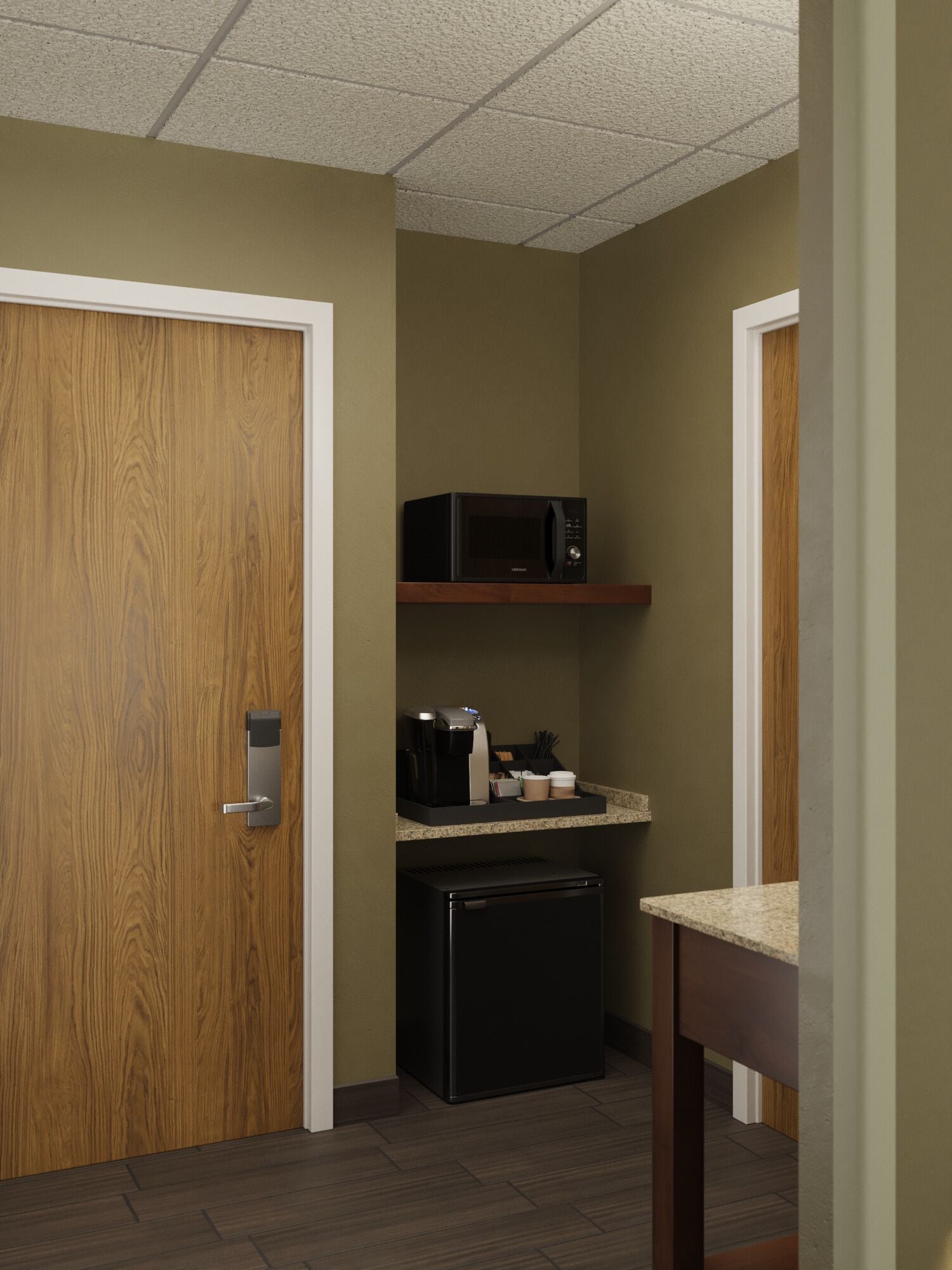 A compact kitchenette with a microwave, coffee maker, and small refrigerator.