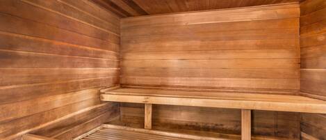 A sauna with wooden walls and benches.