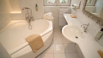 A bathroom with a bathtub, a sink, and a toilet.