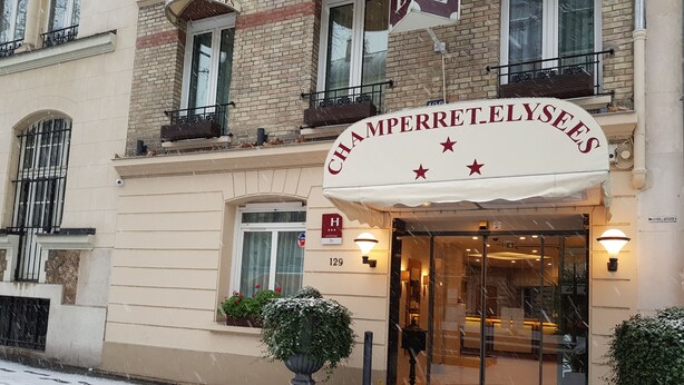 A hotel entrance with a sign reading "CHAMPERRETT ELYSEES". - Hotel Champerret Elysees (Paris)