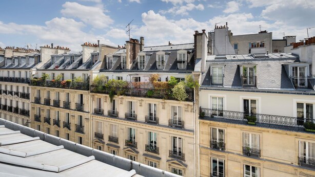A row of Parisian apartment buildings with balconies, under a partly cloudy sky. - ibis Styles Paris Cadet Lafayette (Paris)