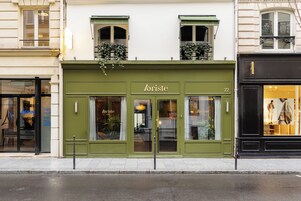 A building with a green facade, the name 'Loriste' on the front, and a number '22' above the entrance.