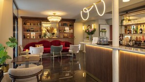 A modern hotel lobby with a bar area, seating arrangements, and a reception desk. - Hotel de Sevigne (Paris)