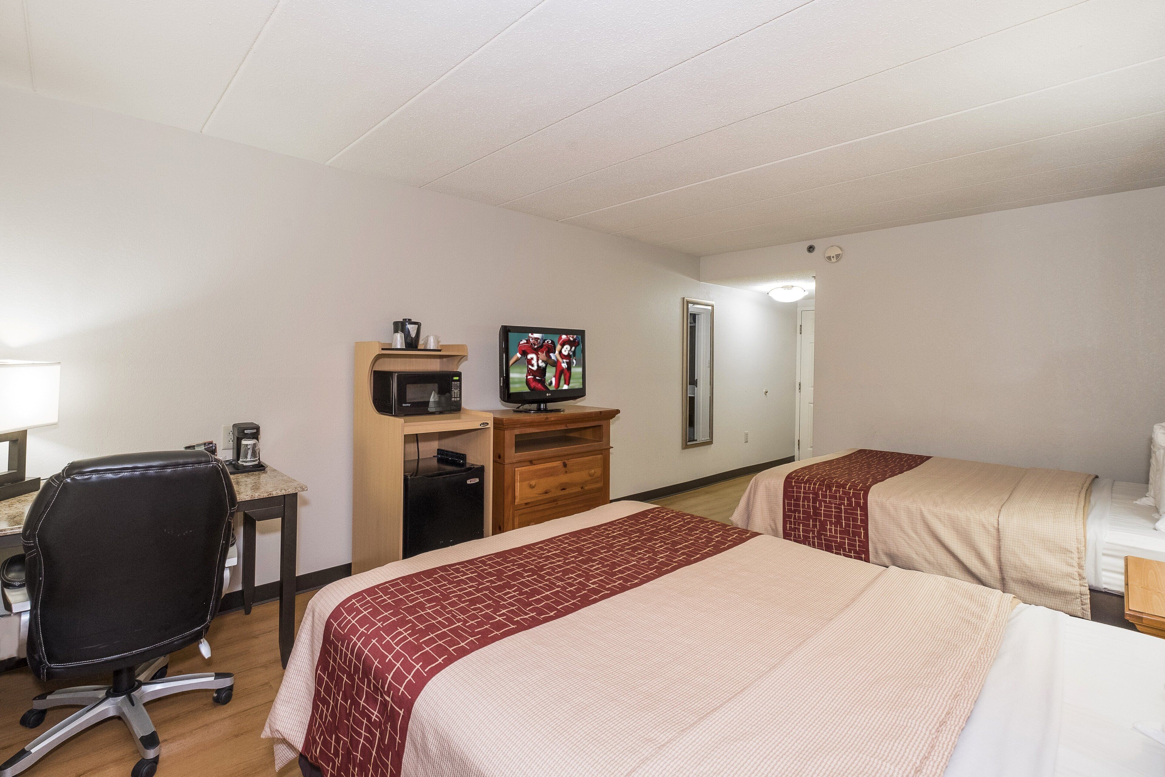 deluxe room, 2 queen beds, non smoking | in-room safe, desk, laptop workspace, blackout curtains