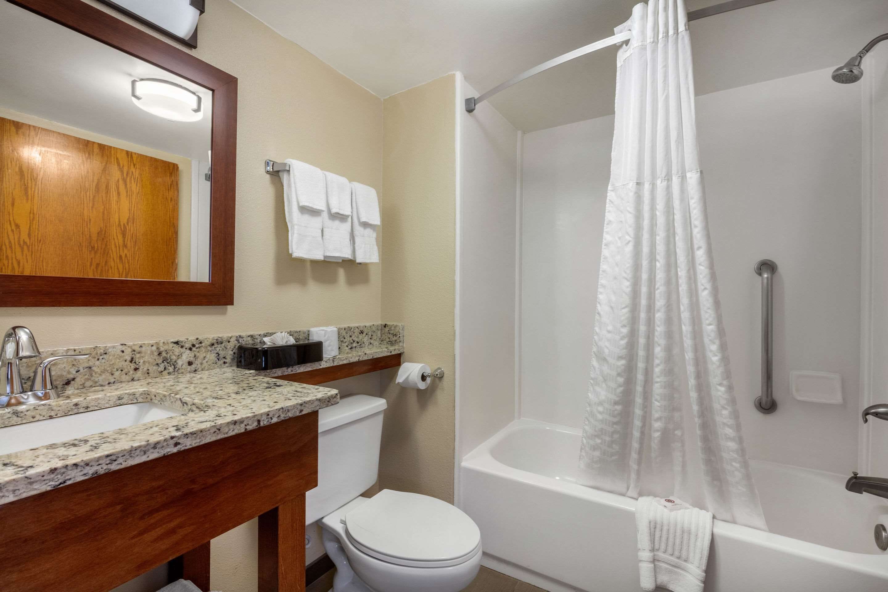 A bathroom with a sink, toilet, and bathtub.