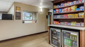 A hotel corridor with vending machines, a refrigerator, and a television on the wall. - Comfort Inn & Suites Hamilton Place (Chattanooga)