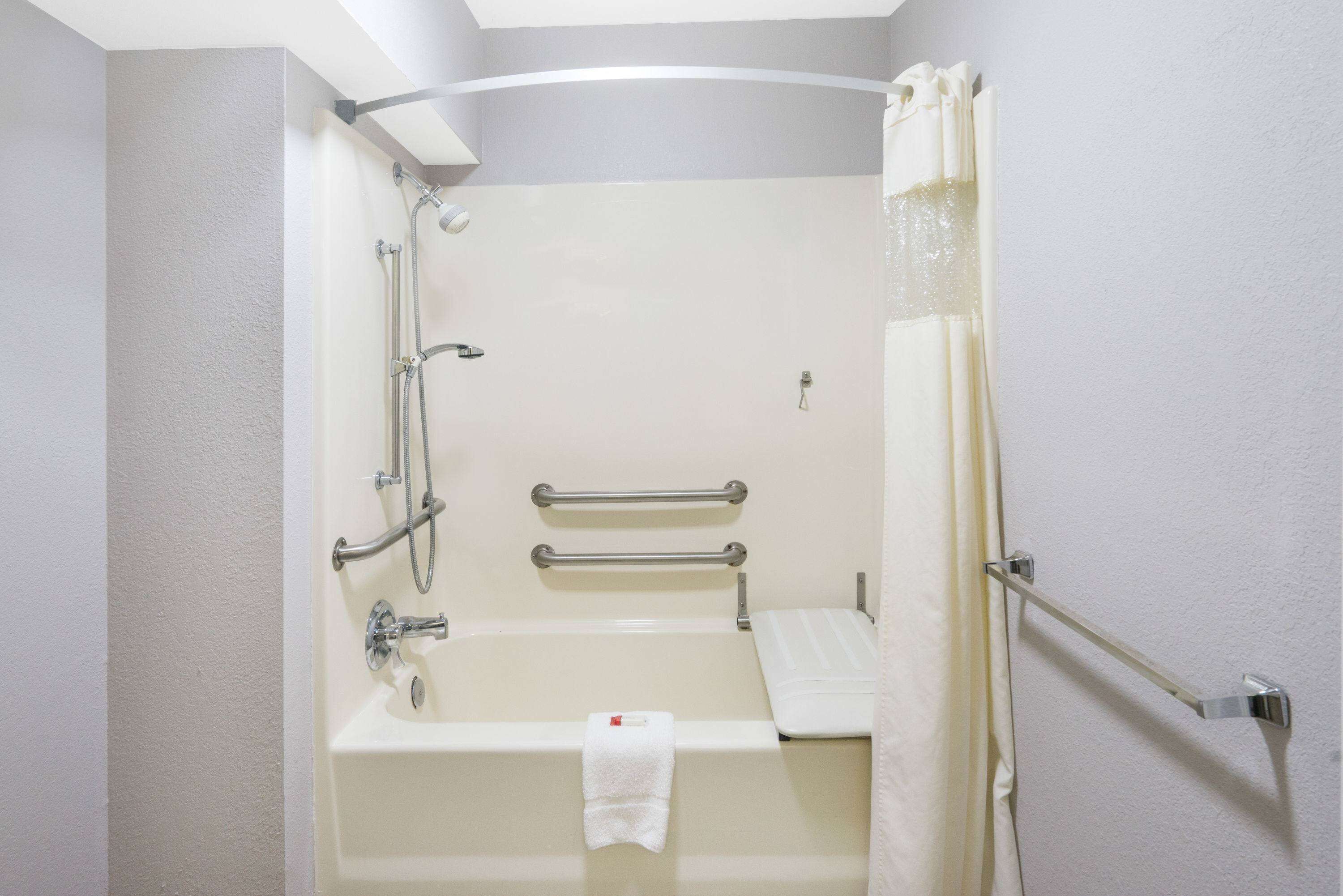 A bathroom with a bathtub, shower, and toilet.