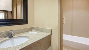 A bathroom with a sink, mirror, and bathtub. - Days Inn by Wyndham Centerville (Centerville)