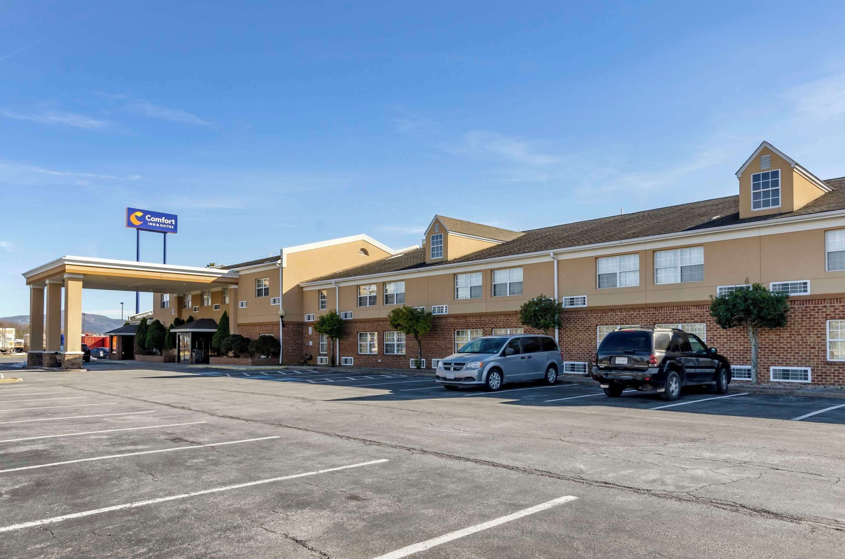 A Comfort Inn with a parking lot and a building with multiple windows and a flat roof.