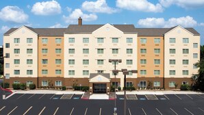 A multi-story hotel with a symmetrical facade, a central entrance, and a parking lot in front. - Fairfield Inn & Suites San Antonio Airport/North Star Mall (San Antonio)