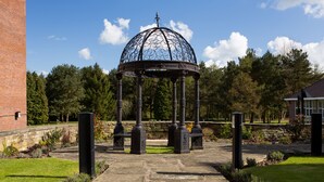 A gazebo with a dome roof, surrounded by a stone pathway and greenery. - Mercure Leeds Parkway Hotel (Leeds)