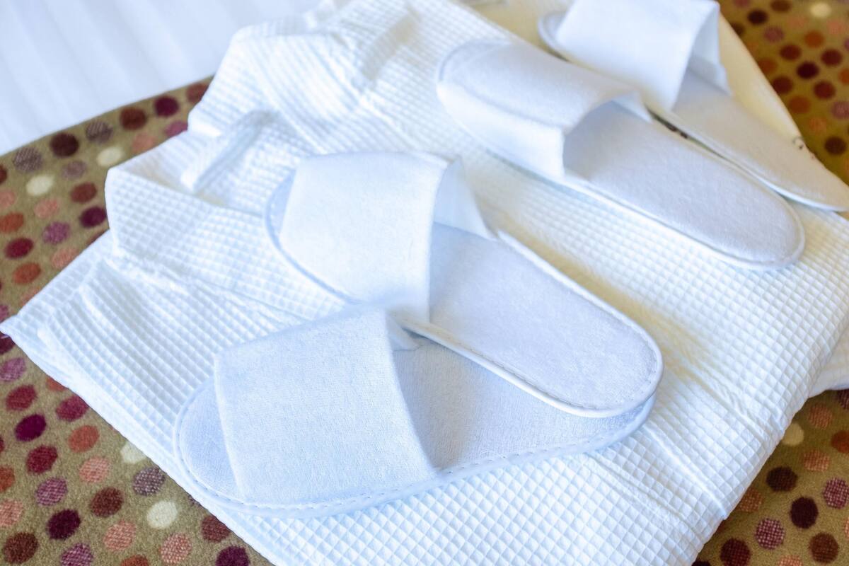 A set of white disposable pads on a patterned cloth.