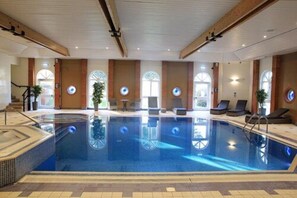 Relax by the rectangular pool surrounded by a tiled deck.