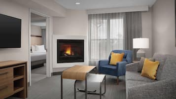 Suite, 2 Double Beds, Fireplace | Living area | 50-inch Smart TV with satellite channels, streaming services