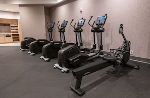 Stay active with our fitness center, featuring stationary bikes and a range of dumbbells for a variety of workouts.