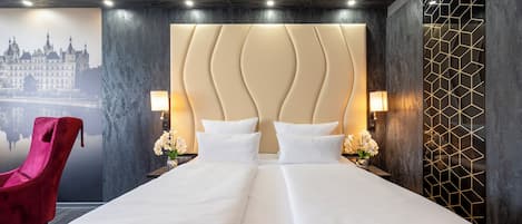 Una habitación de hotel con una cama grande, una silla roja y un mural con un paisaje urbano en la pared.