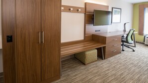 A modern office space with a wooden desk, a large flat-screen TV, and a comfortable chair. - Holiday Inn Express Atlanta-Stone Mountain by IHG (Stone Mountain)