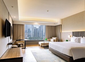 A modern hotel room with a large bed, a desk, a chair, and a television. - Crowne Plaza Hotel Jakarta, an IHG Hotel (Jakarta)