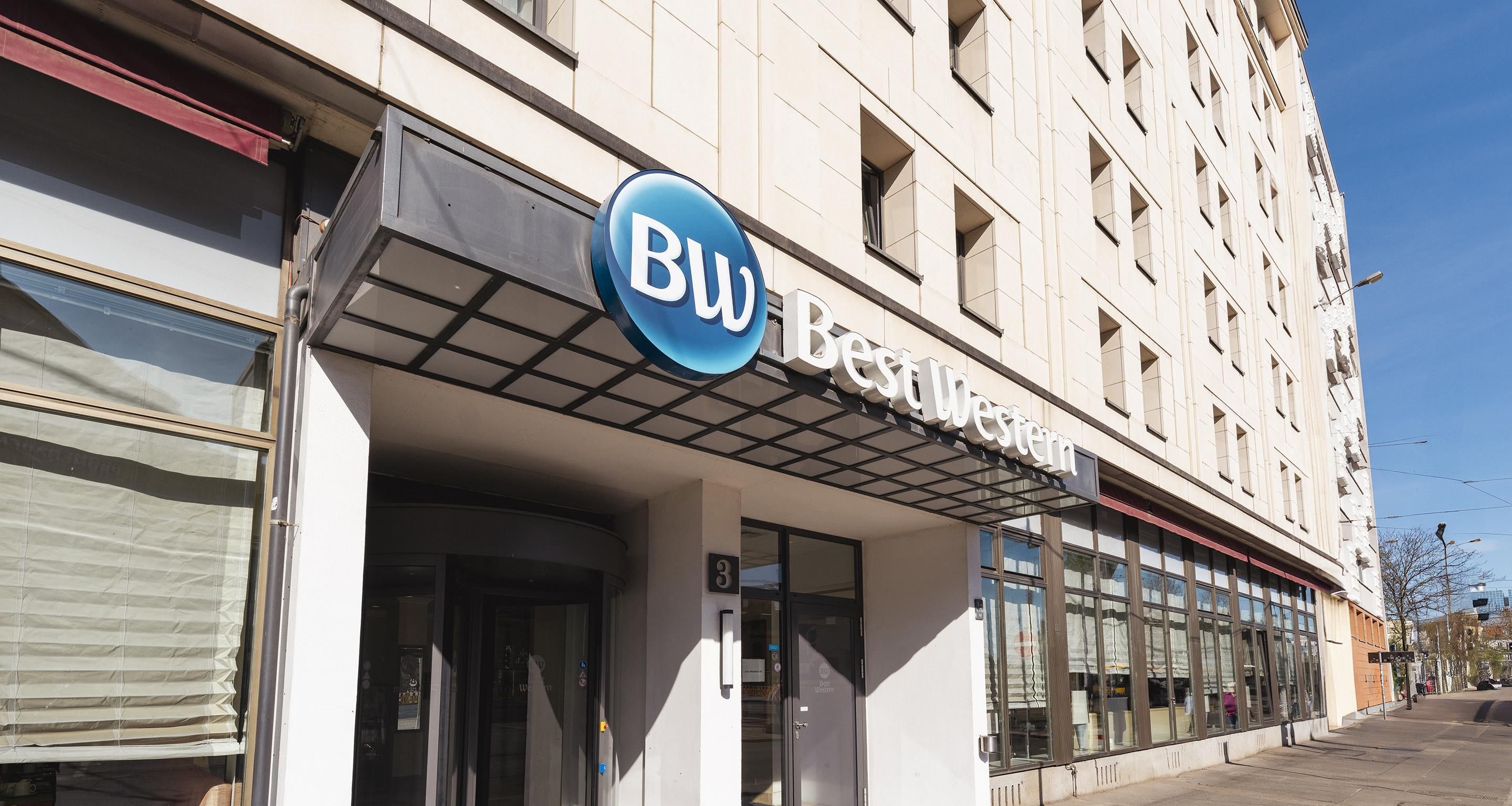 A building with a large blue sign reading 'BW Best Western' and a number '3' indicating its address.