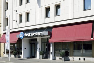 Een hotel met een rode luifel en een bord waarop 'Best Western' staat.