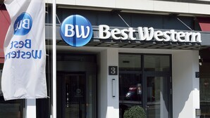 A building with a sign reading "Best Western" and a flag with "BW" and "Best Western" visible. - Best Western Hotel Leipzig City Center (Leipzig)