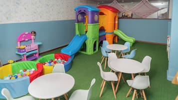 Children can play and dine in this spacious room featuring a colorful play structure, ball pit, and dollhouse.